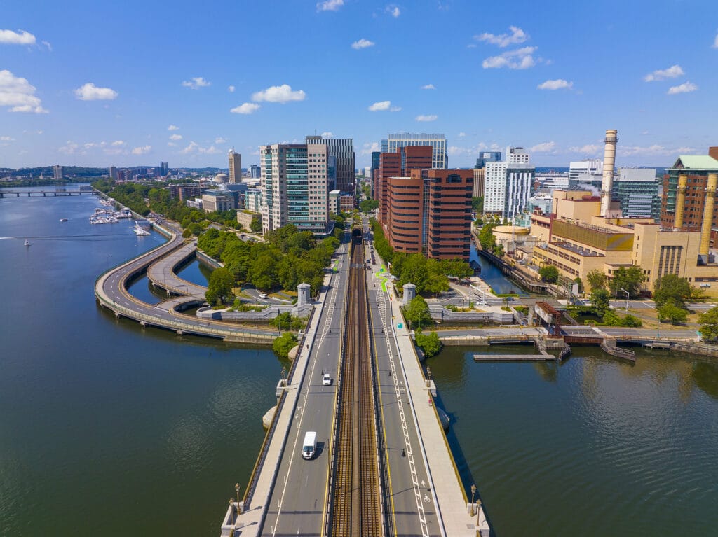 Cambridge Kendall Square skyline and Longfellow Bridge aerial view, Boston, Massachusetts MA, USA. The bridge connects Cambridge and Boston over Charles River is a steel rib arch bridge built in 1906.