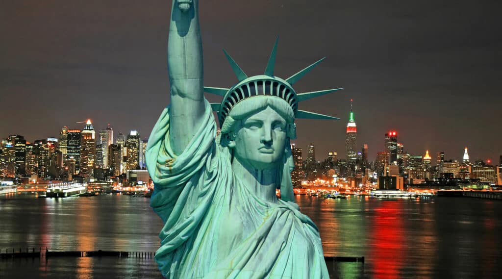 The Statue of Liberty and New York City skylines as the background